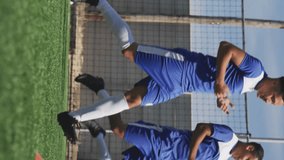 Animation of social media icons over team of diverse male soccer players training on sports field. Social media networking and sports fitness concept - Powered by Shutterstock - Get 15% off with code: PIKWIZARD15