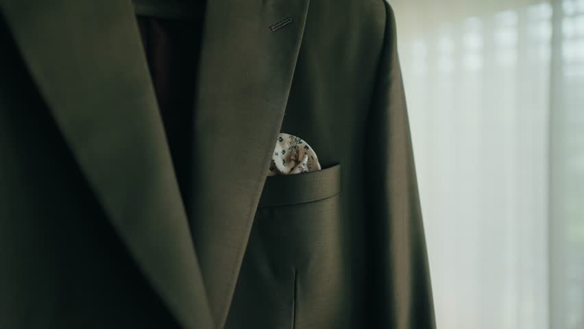 groom suit jacket with folded handkerchief detail indoors
