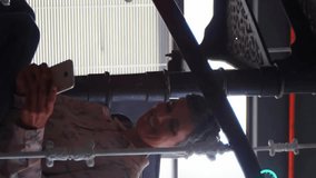 Animation of connected icons globes, woman sitting on staircase and scrolling on cellphone. Digital composite, multiple exposure, communication, notification and technology concept. - Powered by Shutterstock - Get 15% off with code: PIKWIZARD15