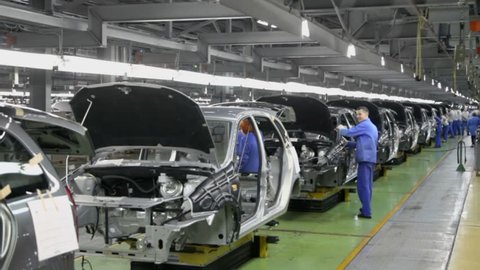 TOGLIATTI - SEP 30: Workers assemble cars Lada Kalina on conveyer of factory VAZ on September 30, 2011 in Togliatti, Russia. AvtoVAZ factory was founded in 1966