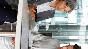 Animation of network of icons over diverse businessman and businesswoman discussing at office. Global networking and business technology concept - Powered by Shutterstock - Get 15% off with code: PIKWIZARD15