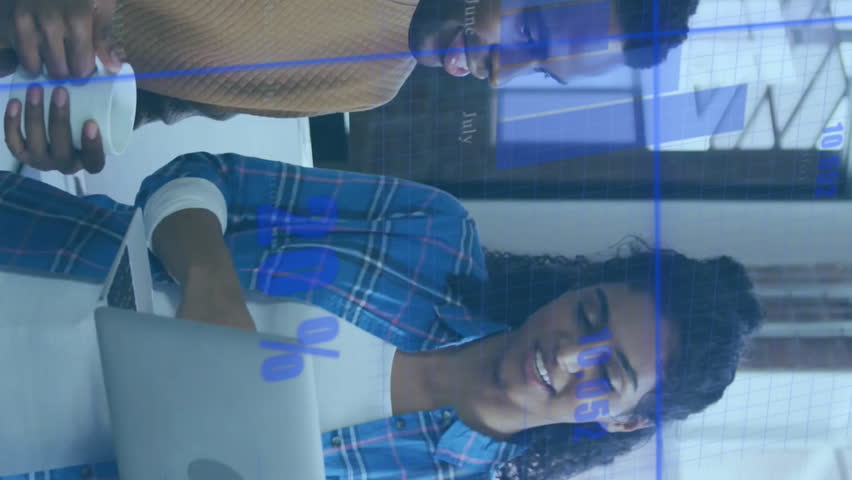 Discussing data with digital charts overlay, two people in modern office. Collaboration, business, technology, analytics, teamwork, innovation - Powered by Shutterstock - Get 15% off with code: PIKWIZARD15