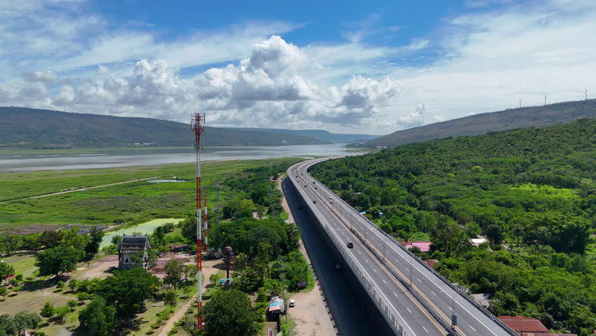 Drone shot The M6 motorway Nakhon Ratchasima Province - Bang Pa-in Lam Ta Khong River and Mountain Drone shot of scenic landscape rural place traffic. Motorway Korat Thailand