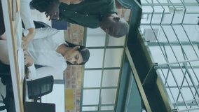 Animation of computer language over diverse coworkers discussing reports on laptop in office. Digital composite, multiple exposure, teamwork, coding, programming language and technology concept. - Powered by Shutterstock - Get 15% off with code: PIKWIZARD15