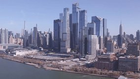 Sweeping aerial pan of Hudson Yards and Midtown Manhattan, capturing waterfront views, skyscrapers, and the Empire State Building. - Powered by Shutterstock - Get 15% off with code: PIKWIZARD15