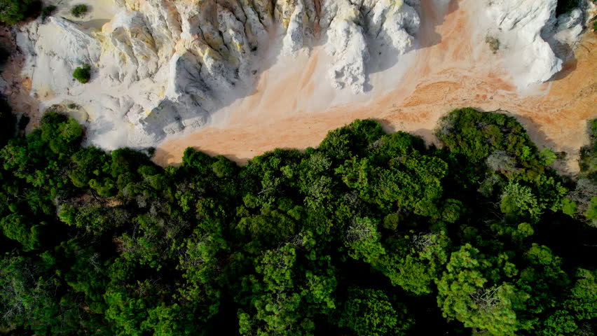 Scenic top-down drone shot of the striking red and white Pinnacle cliffs in Beowa National Park, located near Pambula on the far south coast of NSW, Australia. A natural coastal wonder.
