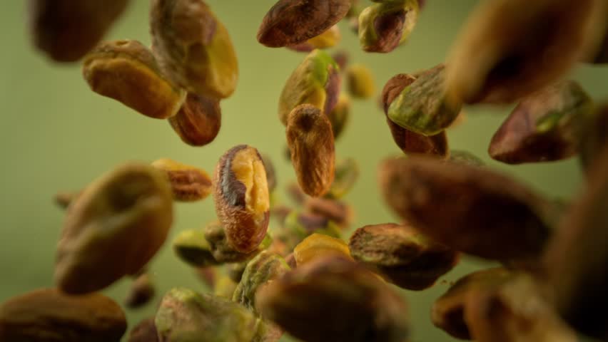 Super Slow Motion Shot of Peeled Pistachio Nuts Falling Around Camera at 1000fps.