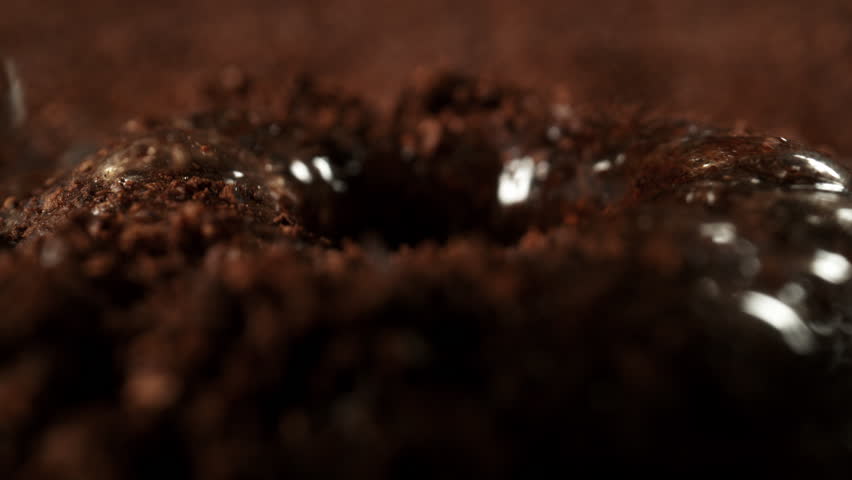Super Slow Motion Detail Shot of Brewing Ground Coffee with Hot Water at 1000fps.