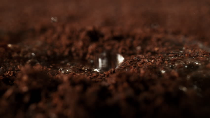 Super Slow Motion Detail Shot of Brewing Ground Coffee with Hot Water at 1000fps.