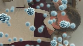 Animation of virus cells over caucasian man with face mask in workshop. hobby during covid 19 pandemic concept digitally generated video. - Powered by Shutterstock - Get 15% off with code: PIKWIZARD15