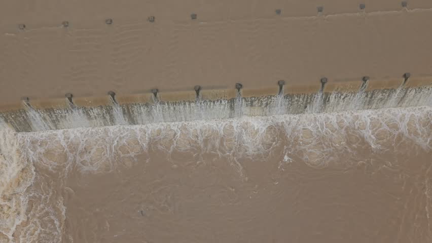 Stunning aerial 4K drone view of a traditional Indian check dam (anikat) surrounded by natural landscape and farmland. Captured in serene rural India.