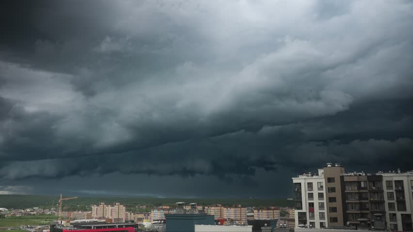 Thunderstorm clouds building, moving, dissipating over metropolitan skyline, revealing dynamic weather patterns transforming urban landscape at dramatic sunset