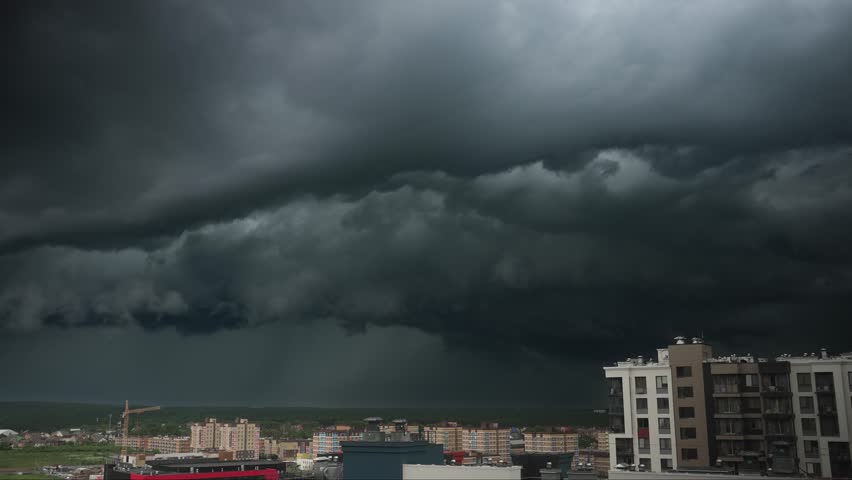 Thunderstorm clouds building, moving, dissipating over metropolitan skyline, revealing dynamic weather patterns transforming urban landscape at dramatic sunset