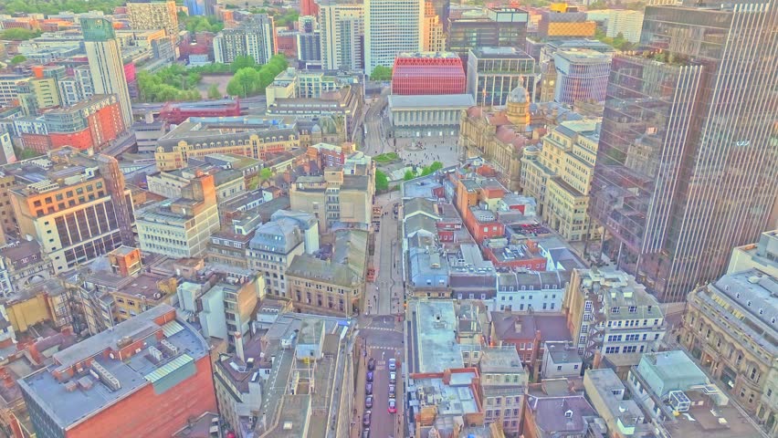Aerial footage captures a dramatic upward view above Birmingham’s downtown, showcasing a blend of historic architecture, modern skyscrapers, and vibrant city streets.