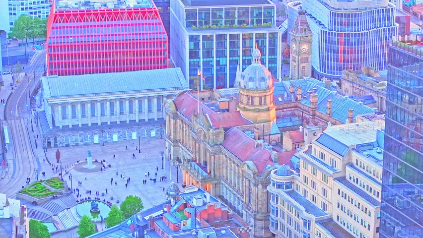 Drone footage captures Pigeon Park and Victoria Square in Birmingham, highlighting the Town Hall, Council House, and iconic city architecture as evening light bathes the urban landscape.