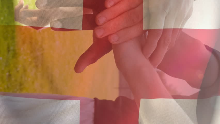 Animation of flag of england and confetti over diverse male soccer players teaming up at stadium. sport and social media concept digitally generated video. - Powered by Shutterstock - Get 15% off with code: PIKWIZARD15