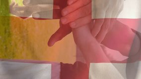 Animation of flag of england and confetti over diverse male soccer players teaming up at stadium. sport and social media concept digitally generated video. - Powered by Shutterstock - Get 15% off with code: PIKWIZARD15