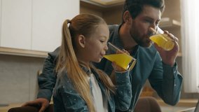 Caucasian positive family in kitchen father dad with custody kid child daughter girl enjoying natural citrus beverage drinking juice watching laptop screen monitor using digital device distance learn - Powered by Shutterstock - Get 15% off with code: PIKWIZARD15