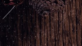Animation of christmas pine cones decoration with snow falling on wood. christmas celebration festivity concept digitally generated image. - Powered by Shutterstock - Get 15% off with code: PIKWIZARD15