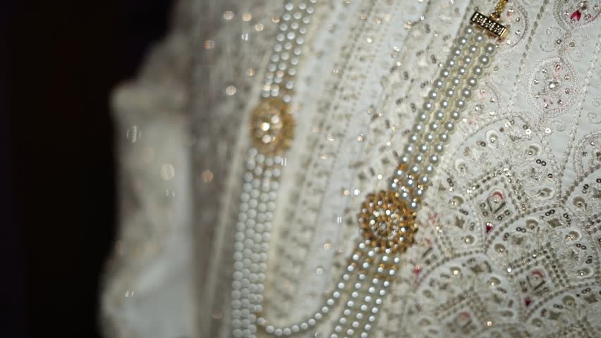 Elegant Groom Wedding Attire with Traditional Accessories and Stylish Details