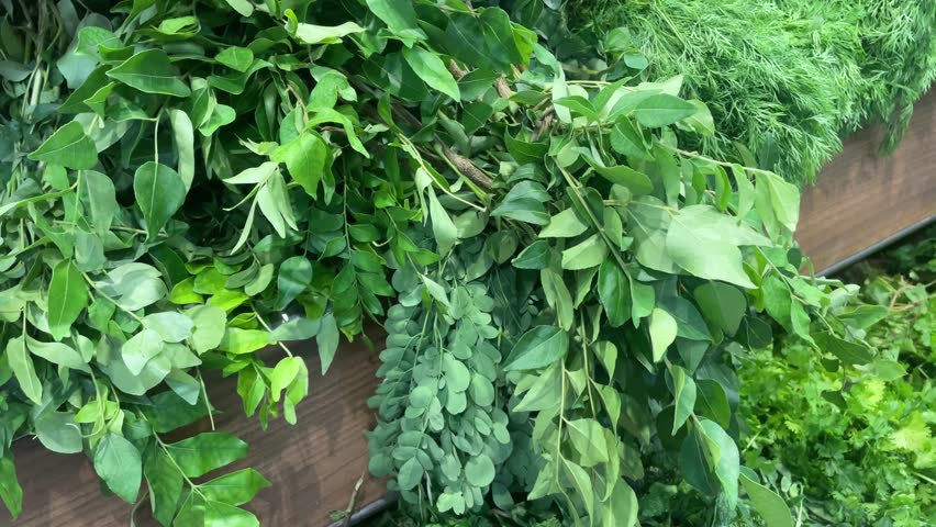 Fresh Leafy Greens and Herbs on Market Display