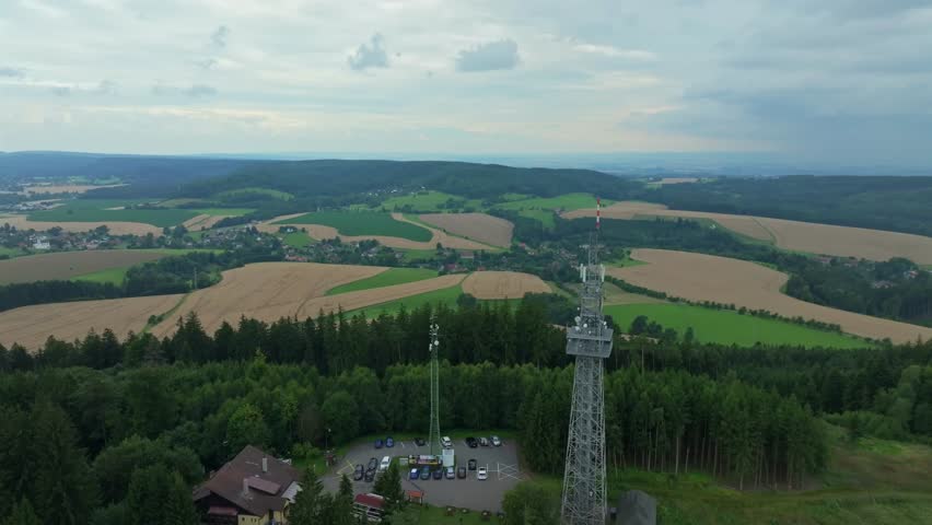 Drone view of the Czech landscape of fields and meadows. In the foreground, the lookout tower at the mouth of the Ústí nad Orlicí
