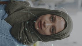 Animation of connected media icons with smiling woman wearing hijab walking in street. communication technology digital interface concept, digitally generated video. media - Powered by Shutterstock - Get 15% off with code: PIKWIZARD15