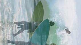 Animation of man surfing over diverse senior couple walking on beach with surfing board. global sports, healthy and active lifestyle concept digitally generated video. - Powered by Shutterstock - Get 15% off with code: PIKWIZARD15