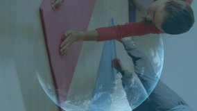 Animation of graphs, data and statistics with globe spinning over Caucasian couple exercising. Public health pandemic coronavirus Covid 19 social distancing and self isolation in quarantine lockdown c - Powered by Shutterstock - Get 15% off with code: PIKWIZARD15