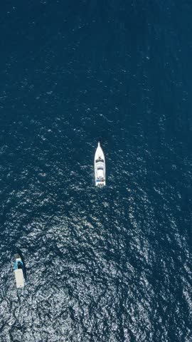 Vertical Drone Shot of Boats Anchored in Deep Blue Sea Water, Top Down Aerial View