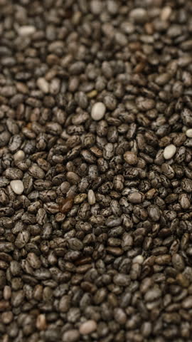 Macro heap of superfood dry chia seeds, rotate