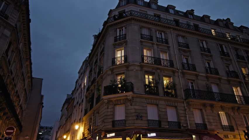 Urban landscape of the night streets of Paris, the capital of France. Architecture of buildings illuminated by street lights on historic tourist streets.