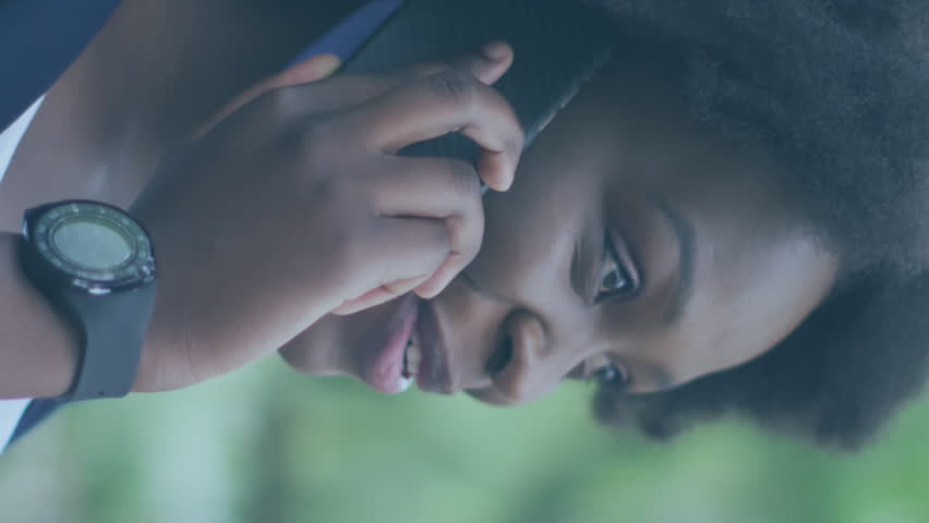 Animation of social media icons over african american woman with face mask using smartphone. Global covid 19 pandemic, social media, and digital interface concept digitally generated video. - Powered by Shutterstock - Get 15% off with code: PIKWIZARD15