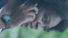 Animation of social media icons over african american woman with face mask using smartphone. Global covid 19 pandemic, social media, and digital interface concept digitally generated video. - Powered by Shutterstock - Get 15% off with code: PIKWIZARD15