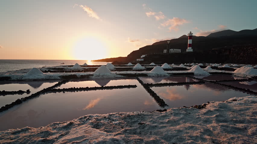 Salt flats at Fuencaliente with lighthouse during sunset, serene mood
