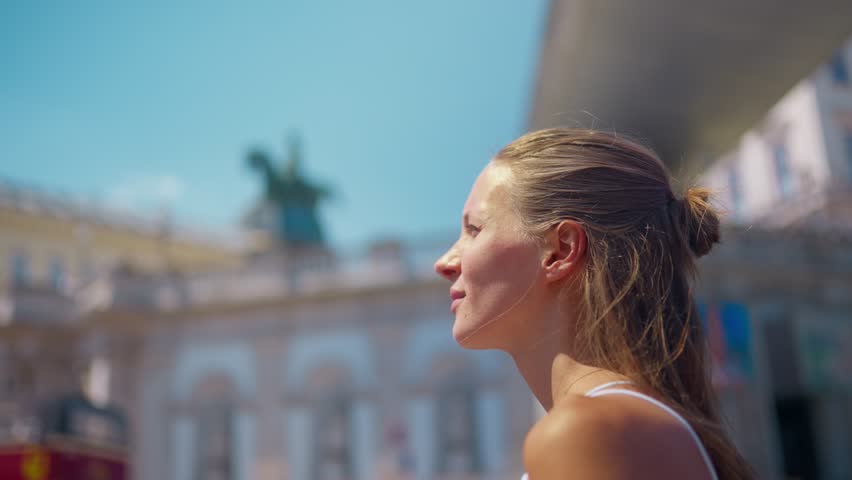 Young woman in white dress walking and exploring downtown Vienna