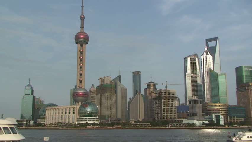 Passenger boat passing Shanghai's famous skyscrapers of Lujiazui district in