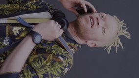 Animation of screens with globes over albino african american man with smartphone. Global social media, communication, connections, computing and data processing concept digitally generated video. - Powered by Shutterstock - Get 15% off with code: PIKWIZARD15