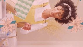 Animation of flowers over happy diverse couple cooking together. Relationship, love, romance and lifestyle concept digitally generated video. - Powered by Shutterstock - Get 15% off with code: PIKWIZARD15