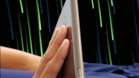 Animation of mid section of woman using digital tablet over green light trails on black background. Global network social media communication concept digitally generated image. - Powered by Shutterstock - Get 15% off with code: PIKWIZARD15