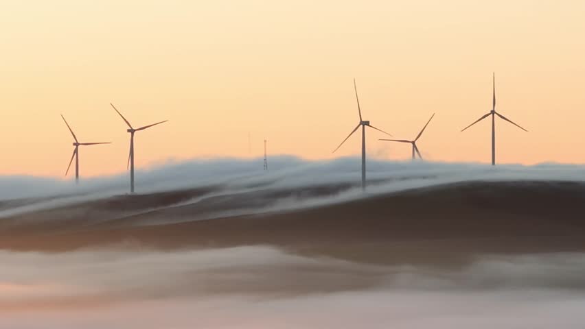 Aerial view of wind turbines shrouded in mist, South Africa.
