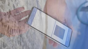 Composition of woman holding a smartphone with qr code on screen against aerial view of the beach. covid-19 vaccination certificate and health pass concept - Powered by Shutterstock - Get 15% off with code: PIKWIZARD15