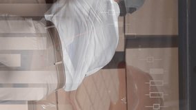 Rear view of a male Caucasian worker taking out packages from his van. Digital animation of graphs and statistics are running in the foreground - Powered by Shutterstock - Get 15% off with code: PIKWIZARD15