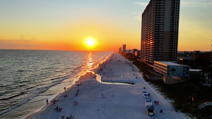 Aerial drone footage of a vibrant sunset over Panama City Beach, Florida, with sweeping shoreline views, ocean waves, and colorful skies. Perfect for travel, tourism, and coastal landscape projects.