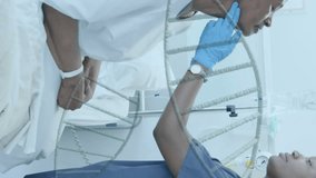 Animation of dna strands over african american female doctor giving senior patient check up. Check up, data, digital interface, connection, hospital and healthcare, digitally generated video. - Powered by Shutterstock - Get 15% off with code: PIKWIZARD15
