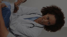 Animation of medical icons over diverse male and female doctors discussing work in hospital. Global medicine, healthcare, hospital and digital interface concept digitally generated video. - Powered by Shutterstock - Get 15% off with code: PIKWIZARD15