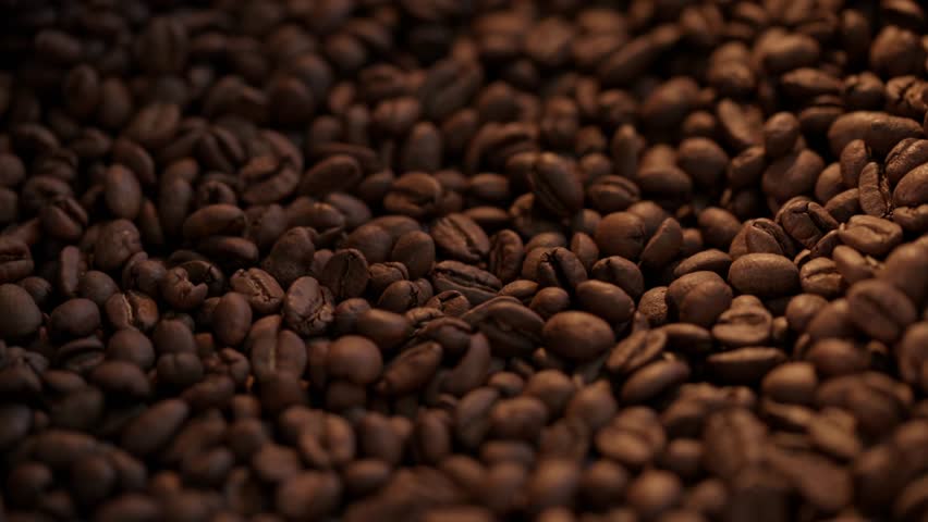 Coffee beans roasting, transformation and aroma release, closeup process.