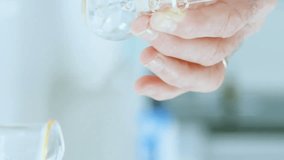 Animation of mathematical equations on mid section of scientist performing experiment at laboratory. Medical research and science technology concept - Powered by Shutterstock - Get 15% off with code: PIKWIZARD15