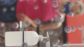 Animation of covid-19 cell over caucasian fit woman wearing face mask applying hand sanitizer at gym. Hygiene and safety during coronavirus covid-19 pandemic concept - Powered by Shutterstock - Get 15% off with code: PIKWIZARD15