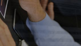 Animation of graphs and trading boards, caucasian coworkers discussing reports on digital tablet. Digital composite, multiple exposure, business, teamwork, stock market and technology concept. - Powered by Shutterstock - Get 15% off with code: PIKWIZARD15